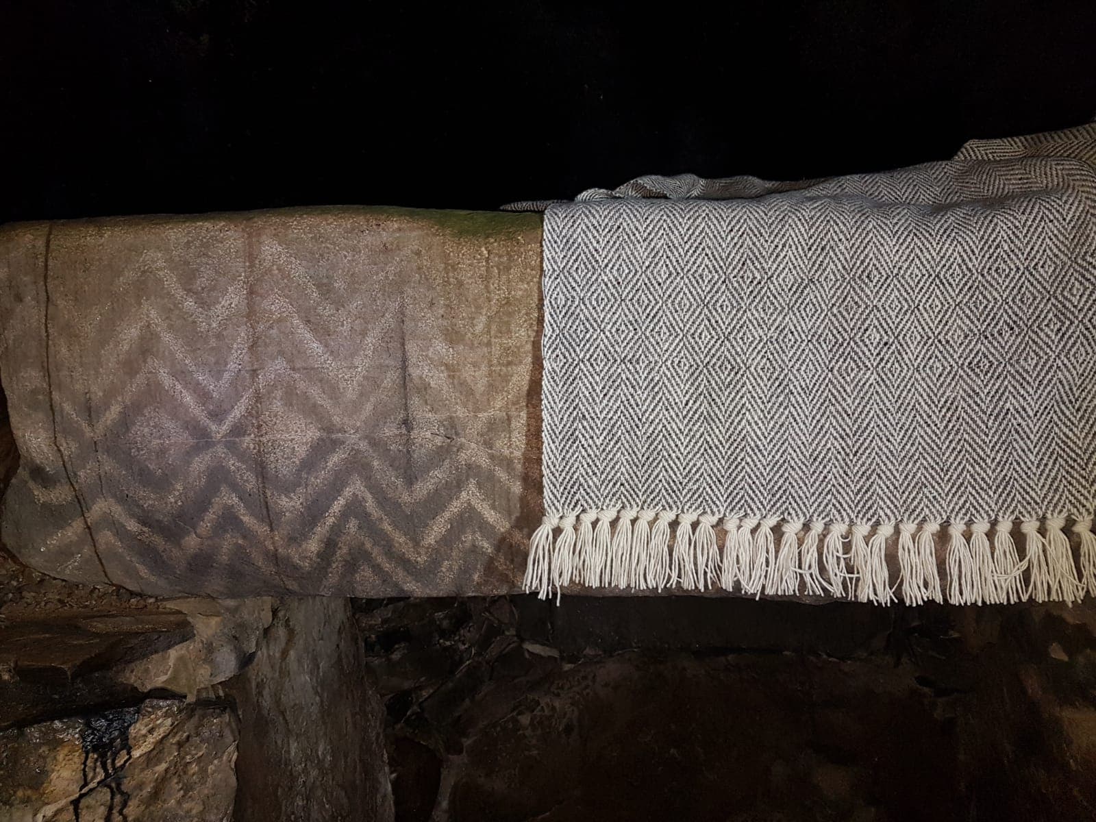 Megalithic Boyne Valley carving beside a handwoven blanket